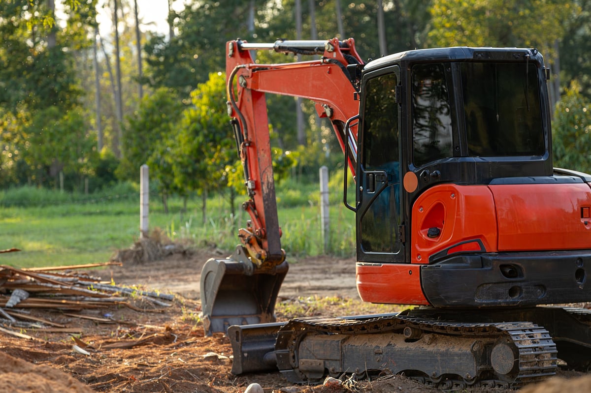 Excavator ready for work on a cleared Southwest Florida construction site.